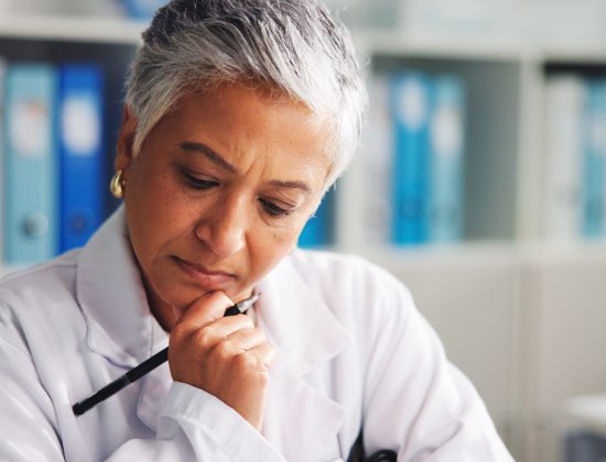 Doctor, woman and serious in office, thinking or research for medical diagnosis, service or project. Healthcare, specialist and mature person with info for treatment plan, reflection and hospital.