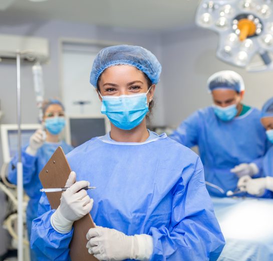 Surgeon writing on clipboard in operation room